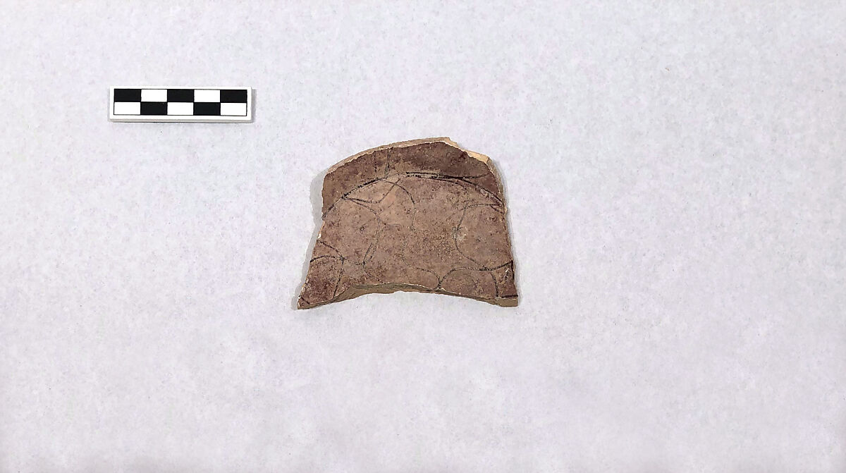 Fragment of a Bowl, Earthenware; reddish buff body, white slip, sgraffito decoration under purplish glaze 