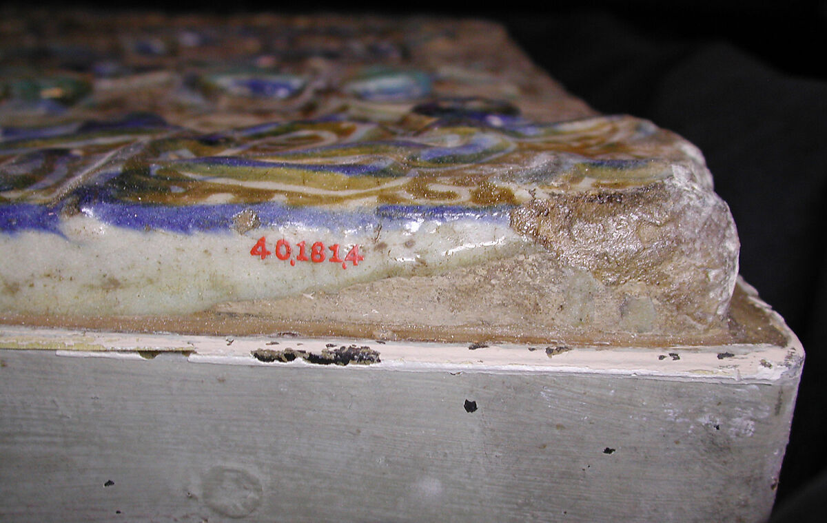 Tile with Niche Design and Inscription, Stonepaste; inglaze painted in blue, luster-painted on opaque white glaze, modeled decoration