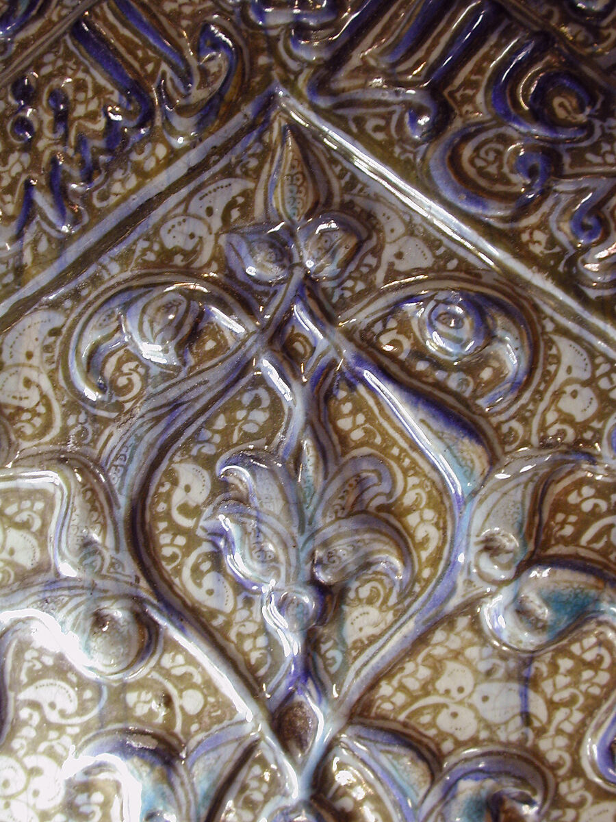 Tile with Niche Design and Inscription, Stonepaste; inglaze painted in blue, luster-painted on opaque white glaze, modeled decoration