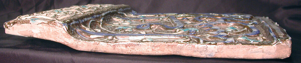 Tile from an Inscriptional Frieze, Stonepaste; modeled, inglaze painted in blue,  luster-painted on opaque white glaze