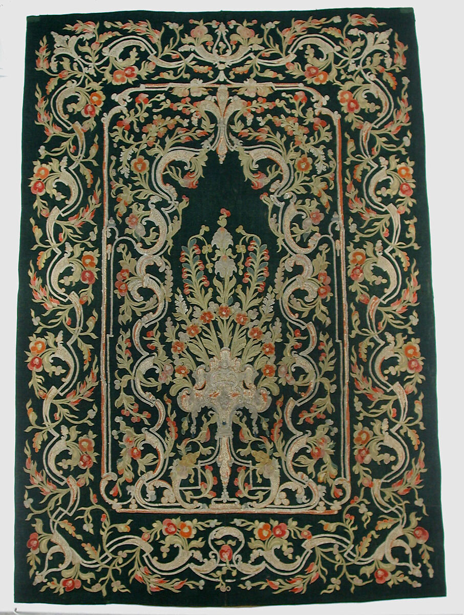 Hanging, Wool; design in wool applique outlined in silk, broken scrolls in silver thread couched in brickwork pattern; lining of brown satin. 