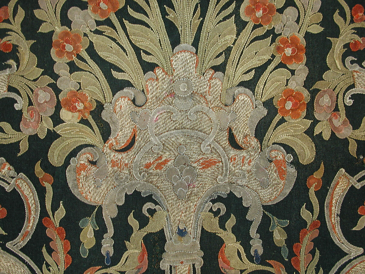 Hanging, Wool; design in wool applique outlined in silk, broken scrolls in silver thread couched in brickwork pattern; lining of brown satin.