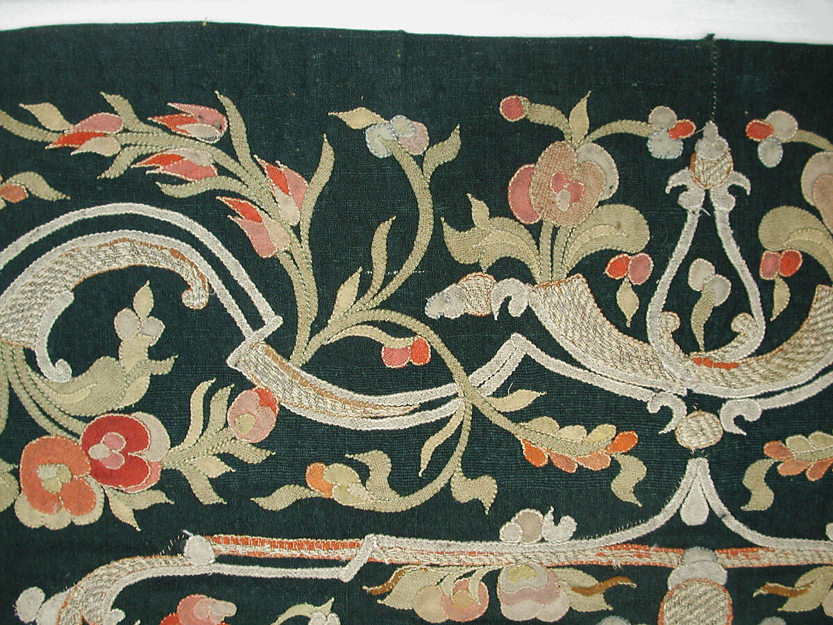 Hanging, Wool; design in wool applique outlined in silk, broken scrolls in silver thread couched in brickwork pattern; lining of brown satin.