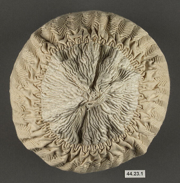 Cap, Cotton; quilted diagonally, border of punch work embroidery edged with crocheted cotton lace