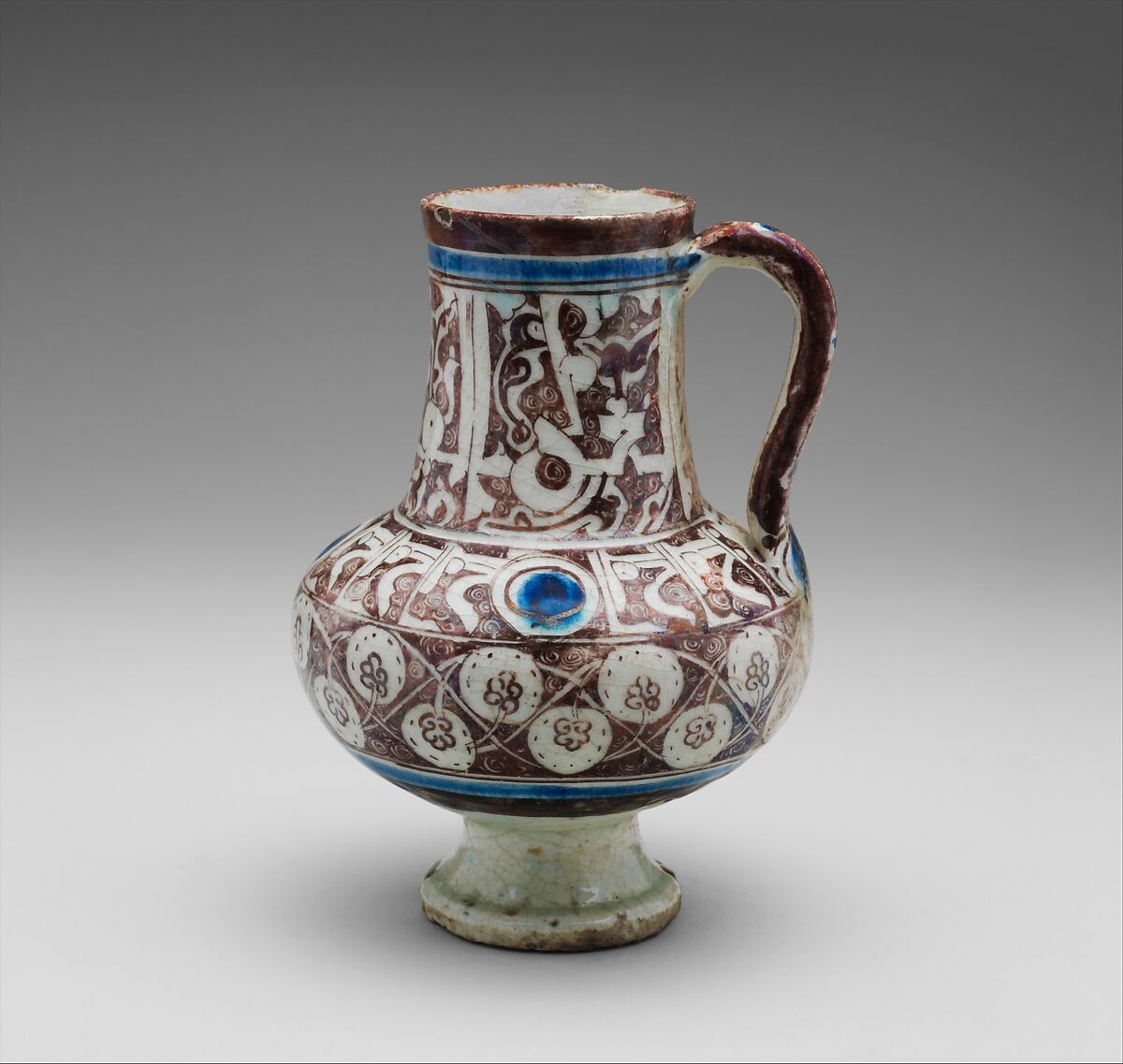 Ewer Inscribed with "al-'izz" ("Glory") in Floriated Kufic on its Neck, Stonepaste; painted in luster and blue on opaque white glaze under transparent glaze 