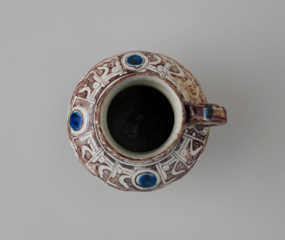 Ewer Inscribed with "al-'izz" ("Glory") in Floriated Kufic on its Neck, Stonepaste; painted in luster and blue on opaque white glaze under transparent glaze