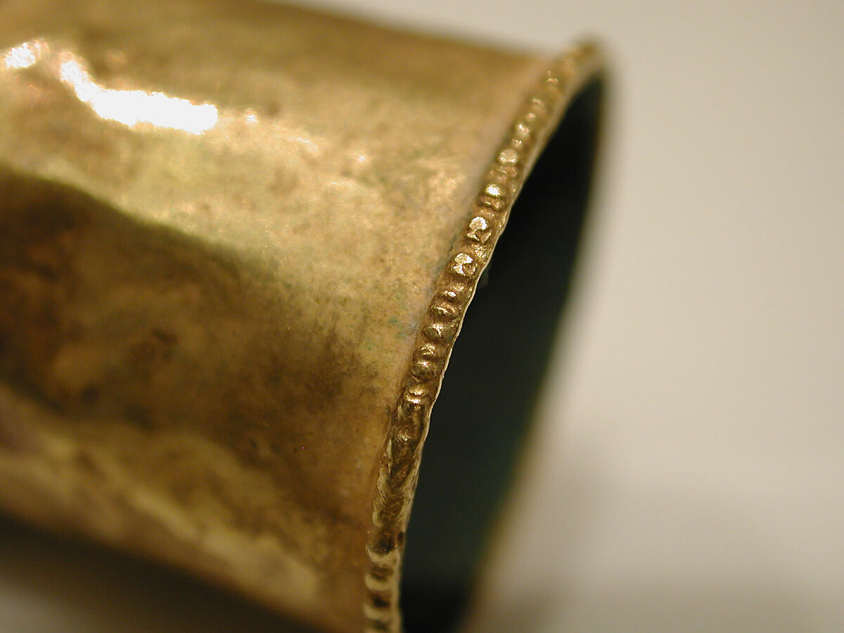 Hair Ornament, One of a Pair, Gold; cast, fabricated, engraved, with a copper alloy inner sleeve, decorated with twisted wire and granulation