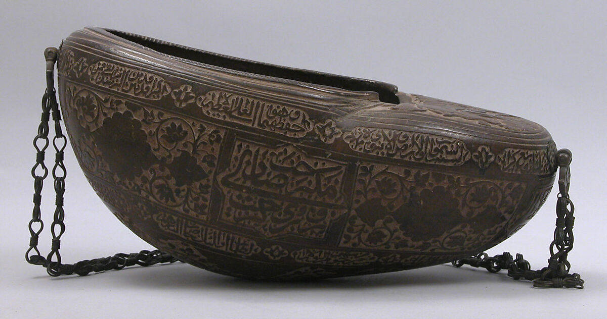 Begging Bowl (Kashkul), Coco-de-mer shell; carved, metal chain