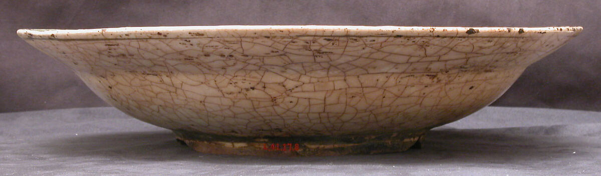 Dish, Stonepaste; underglaze painted in black, blue, and green with red and yellow slips