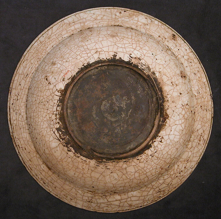 Dish, Stonepaste; underglaze painted in black, blue, and green with red and yellow slips