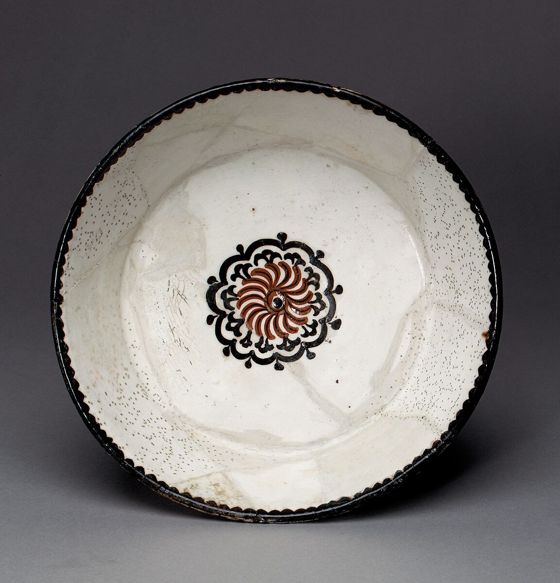 Bowl with Rosette, Earthenware; white slip with polychrome slip decoration under transparent glaze