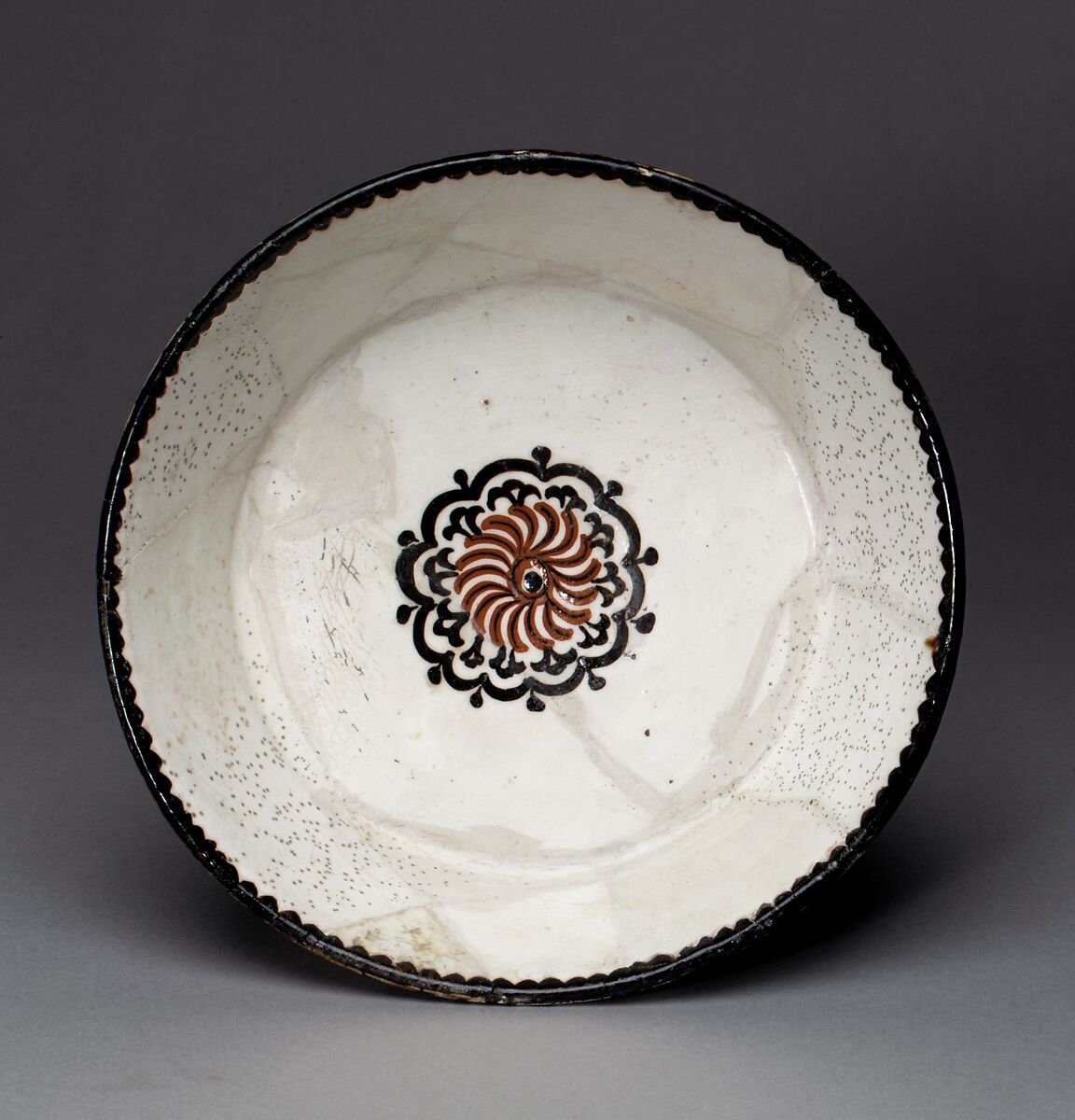 Bowl with Rosette, Earthenware; white slip with polychrome slip decoration under transparent glaze 