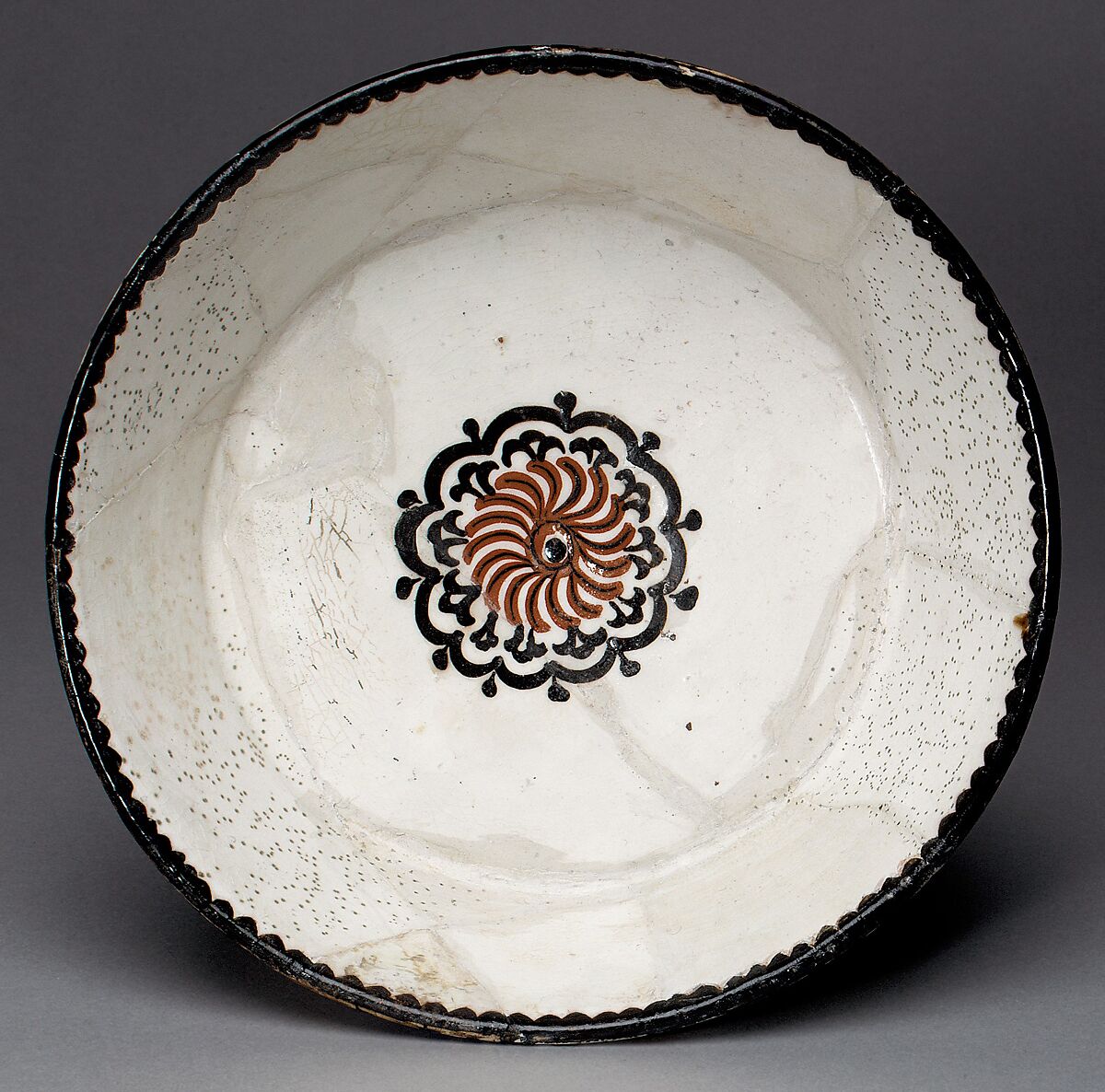Bowl with Rosette, Earthenware; white slip with polychrome slip decoration under transparent glaze