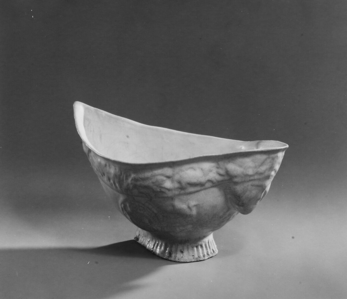 Boat-Shaped Bowl with Human Head and Animals, Stonepaste; molded, opaque white glaze
