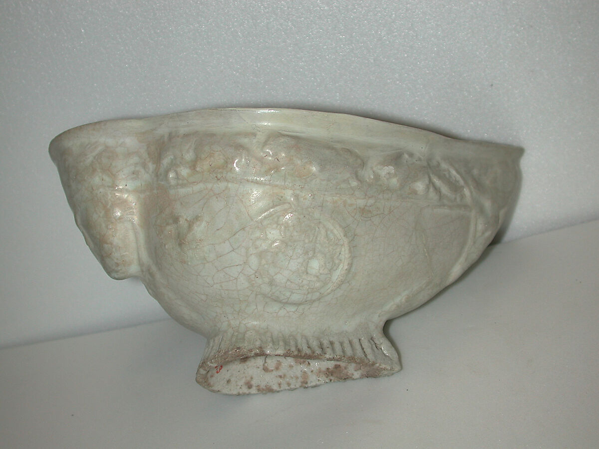 Boat-Shaped Bowl with Human Head and Animals, Stonepaste; molded, opaque white glaze