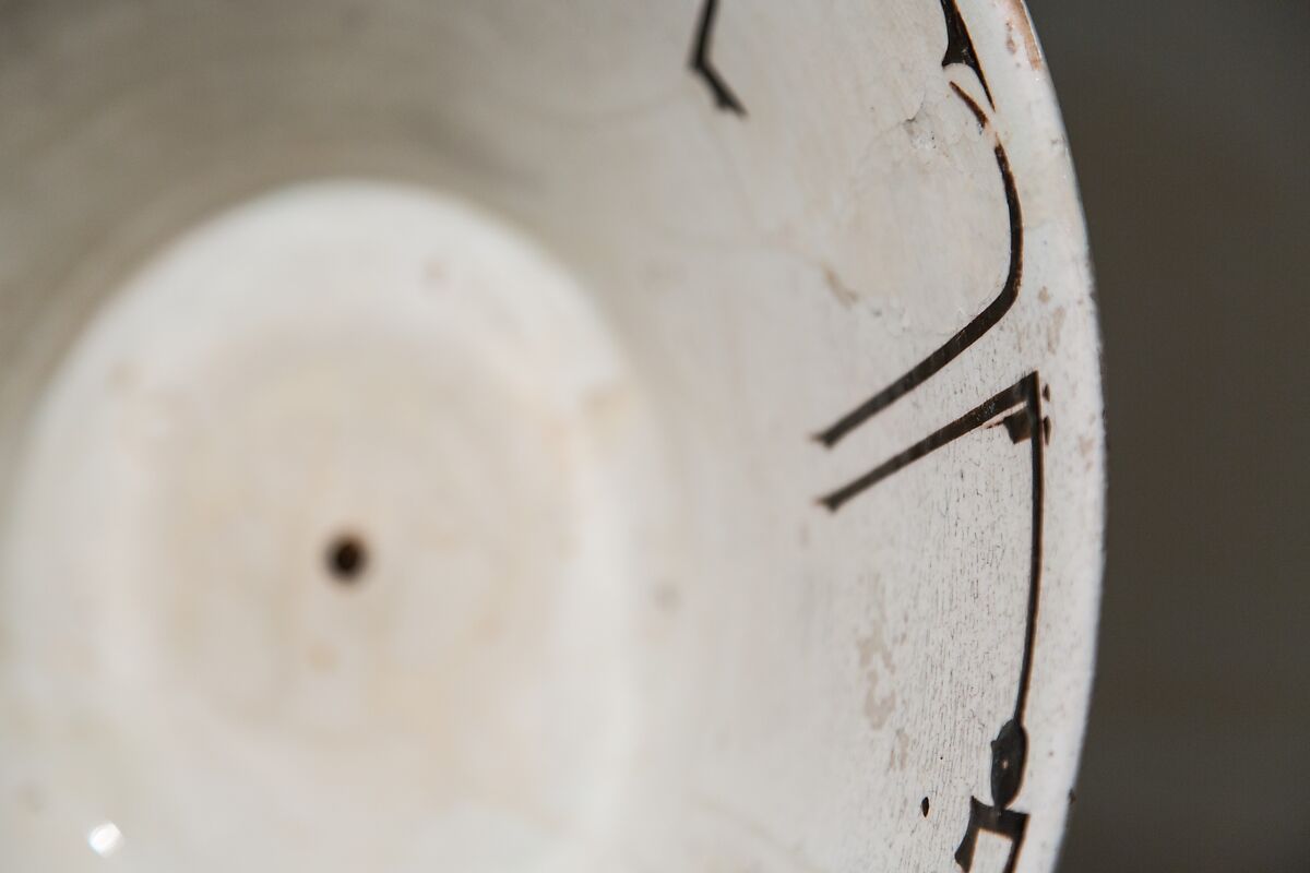 Bowl with Arabic Inscription, Earthenware; white slip with black-slip decoration under transparent glaze
