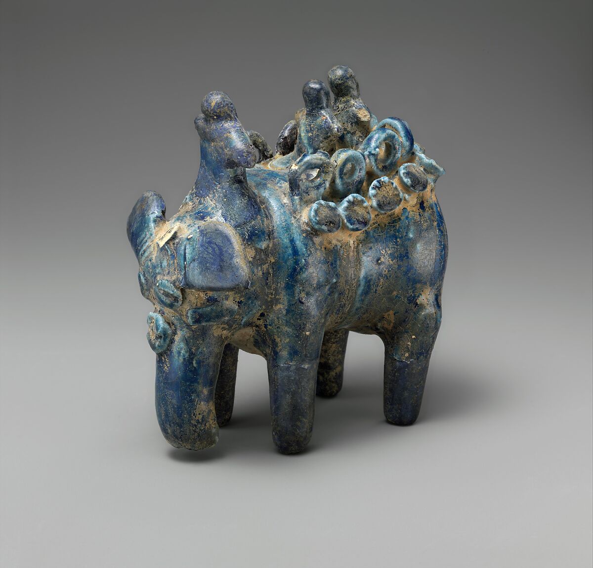 Elephant Carrying Two Figures Seated on Hawda and Mahout Seated on Neck, Stonepaste; molded, transparent blue glaze 