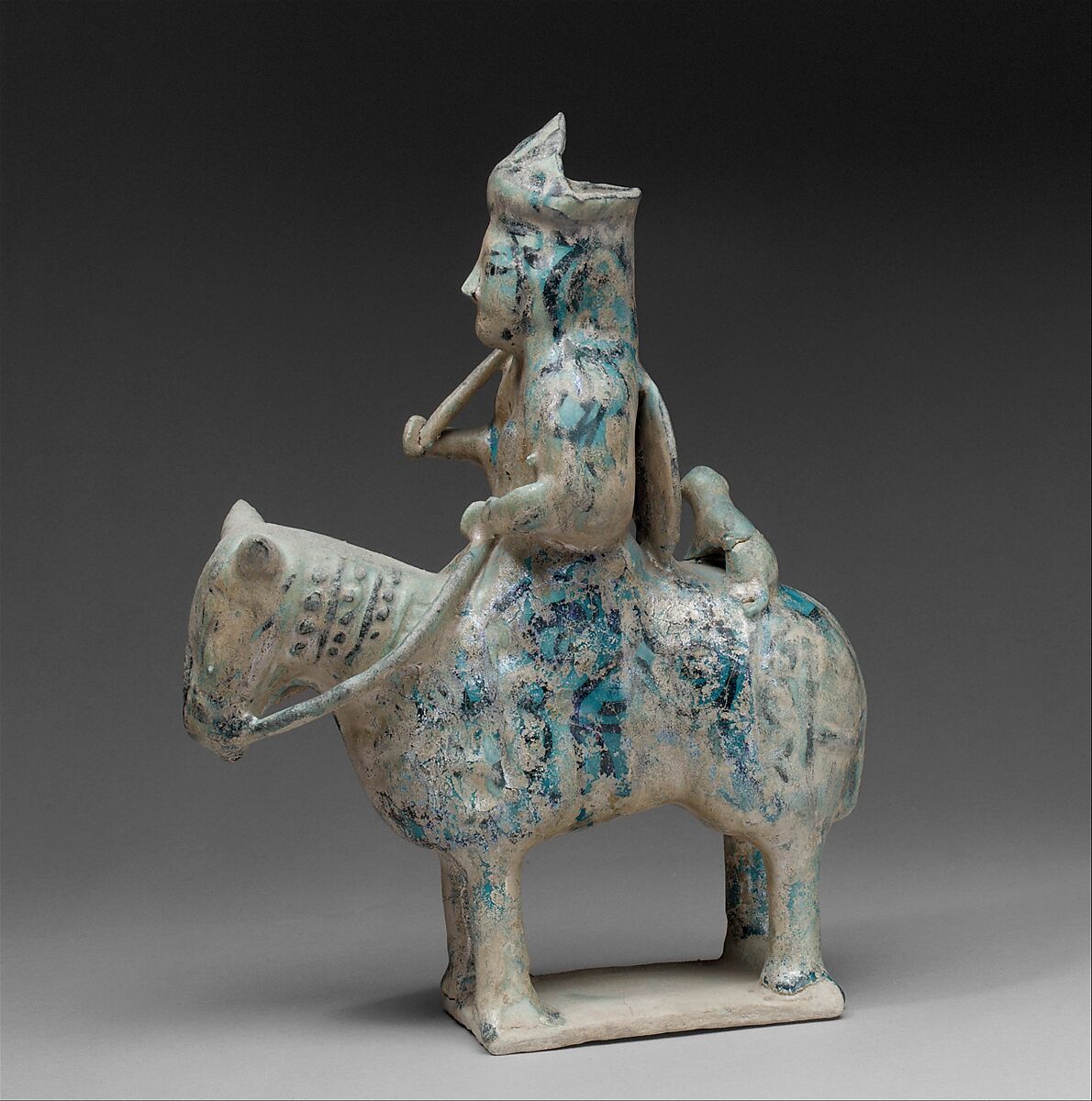 Mounted Hunter with Cheetah, Stonepaste; molded in sections, glazed in transparent turquoise, underglaze-painted in black 