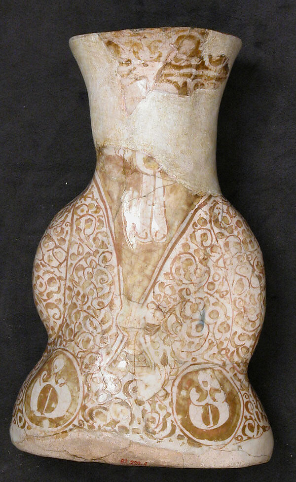 Hollow Vessel in the Shape of a Woman Holding a Child, Stonepaste; molded, luster-painted on an opaque white glaze