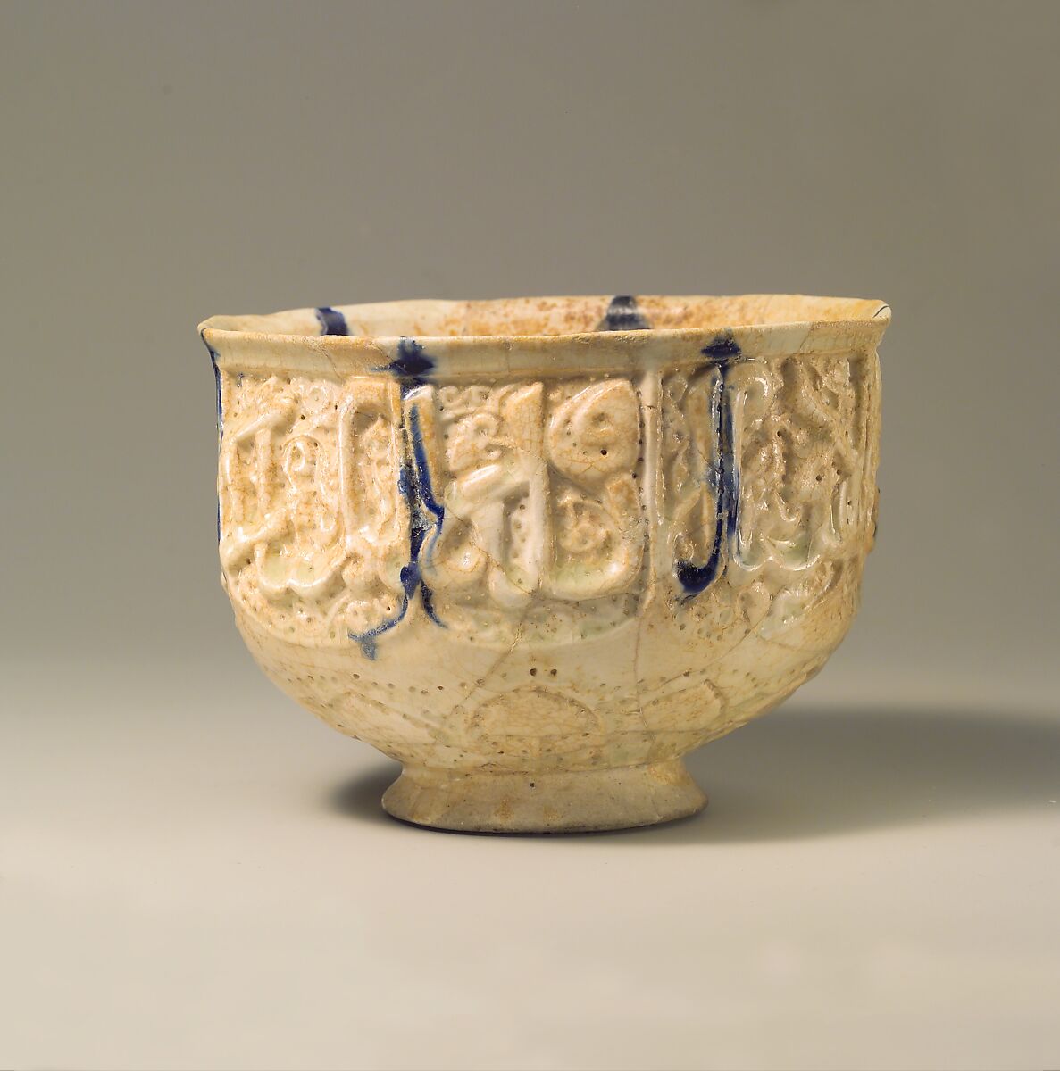 Pierced Bowl Signed by Hasan al-Qashani, Stonepaste; molded and pierced, monochrome decoration under transparent glaze 