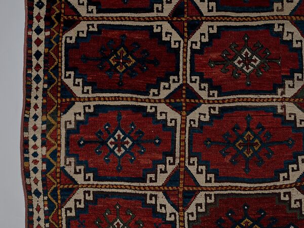 Carpet with Repeating Medallion Pattern on Red Background, Wool; (warp, weft, and pile); symmetrically knotted pile