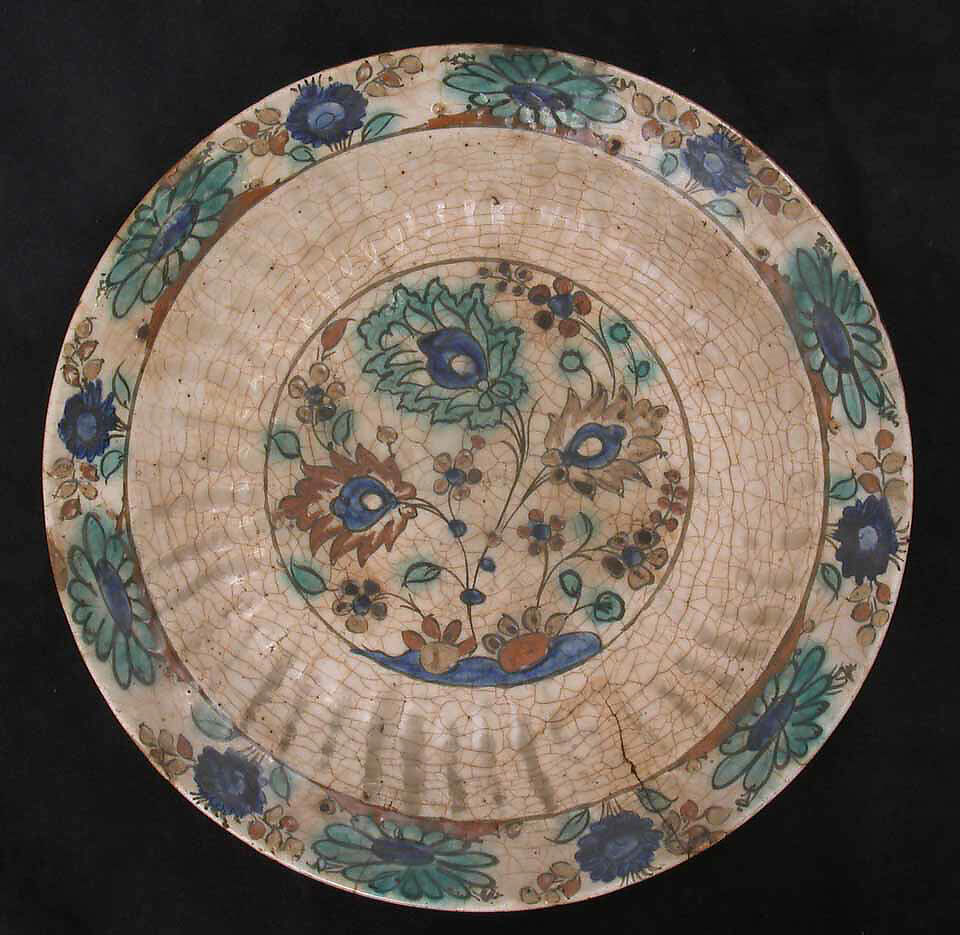 Dish, Stonepaste; underglaze painted in black, blue, and green with red and yellow slips 