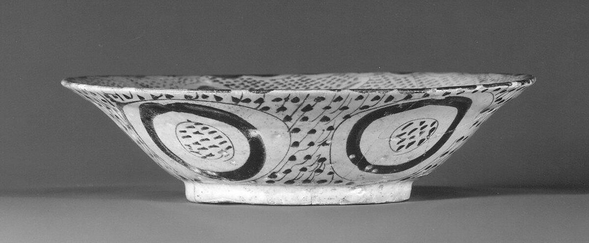 Bowl depicting a Man holding a Cup and a Flowering Branch, Earthenware; luster-painted on opaque white glaze