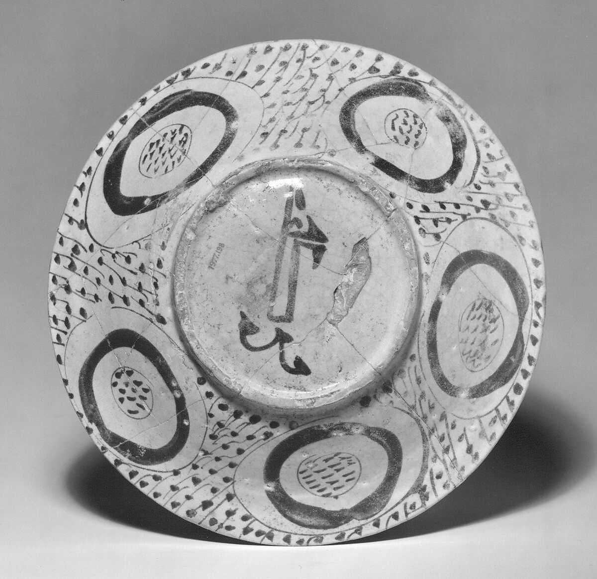 Bowl depicting a Man holding a Cup and a Flowering Branch, Earthenware; luster-painted on opaque white glaze