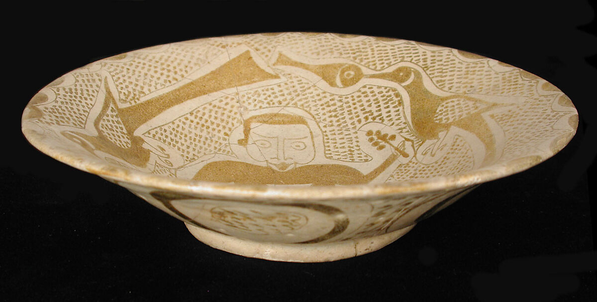 Bowl depicting a Man holding a Cup and a Flowering Branch, Earthenware; luster-painted on opaque white glaze