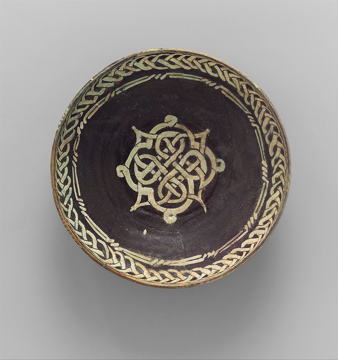 Bowl with Knotted Medallion, Earthenware; black slip with white slip decoration under transparent glaze 