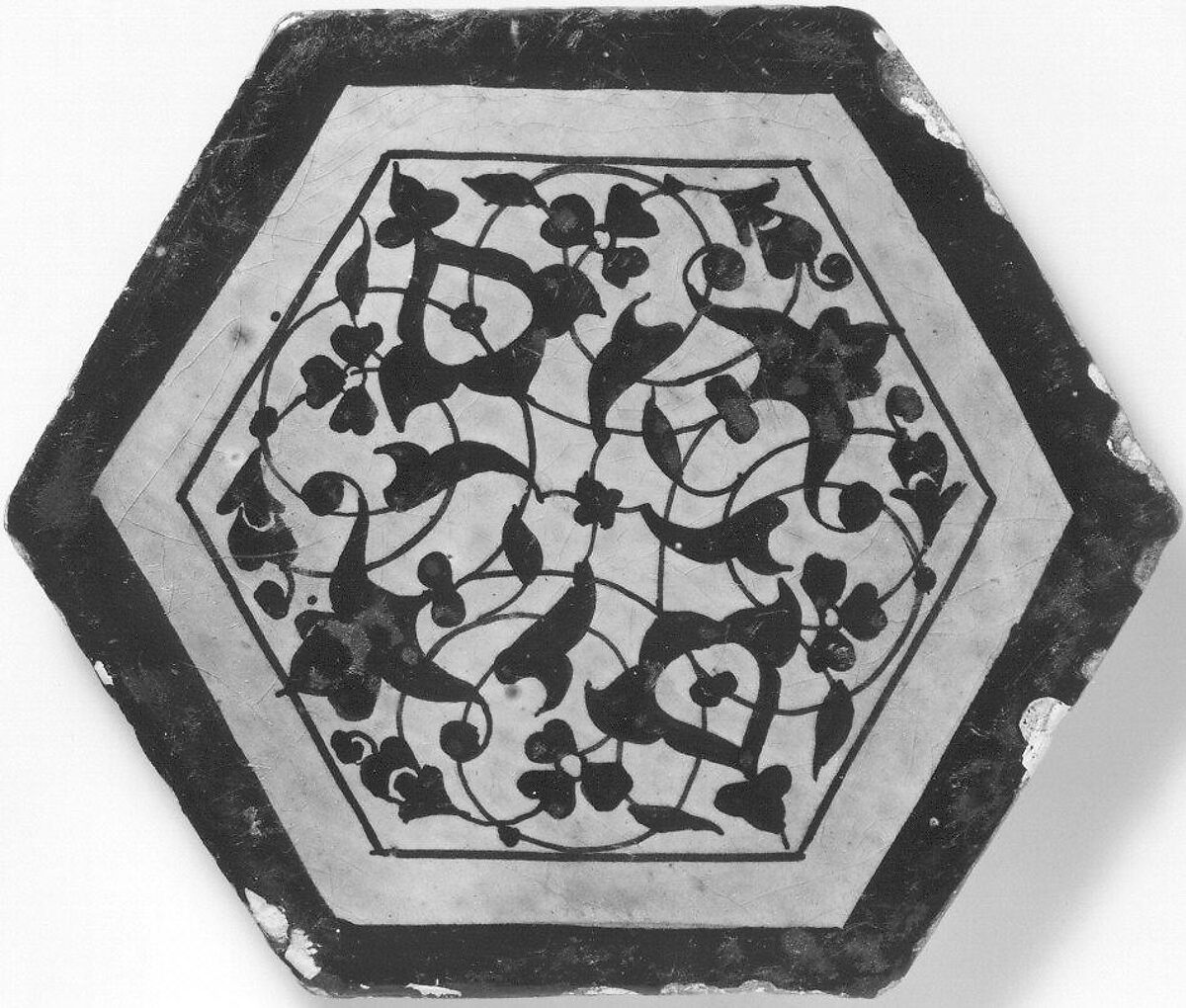Hexagonal Tile, Earthenware; painted in black on a white ground under green glaze with traces of overglaze gold 
