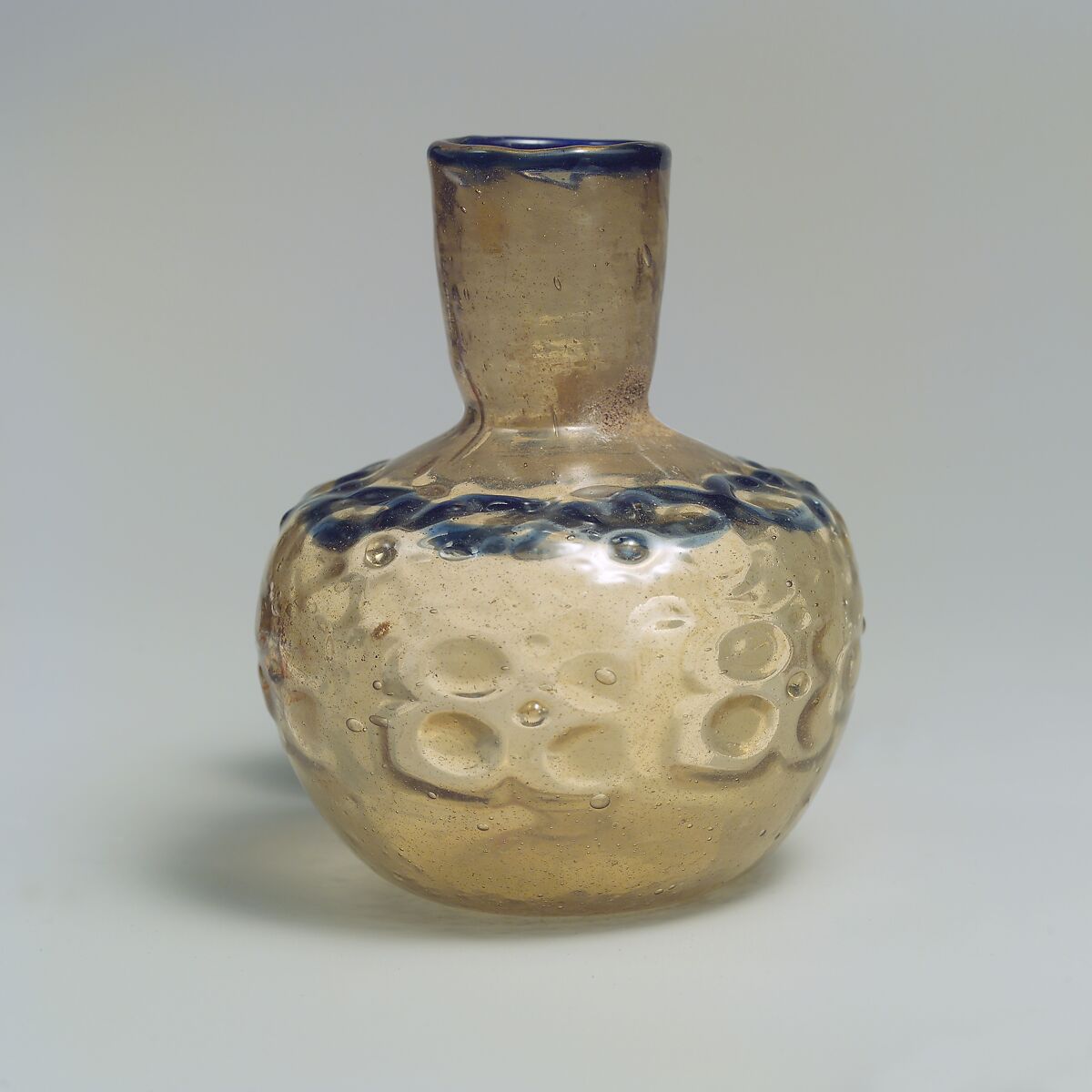 Short-Necked bottle, Glass, colorless with brown tinge; blown, impressed with tongs, applied blue rim and decoration 