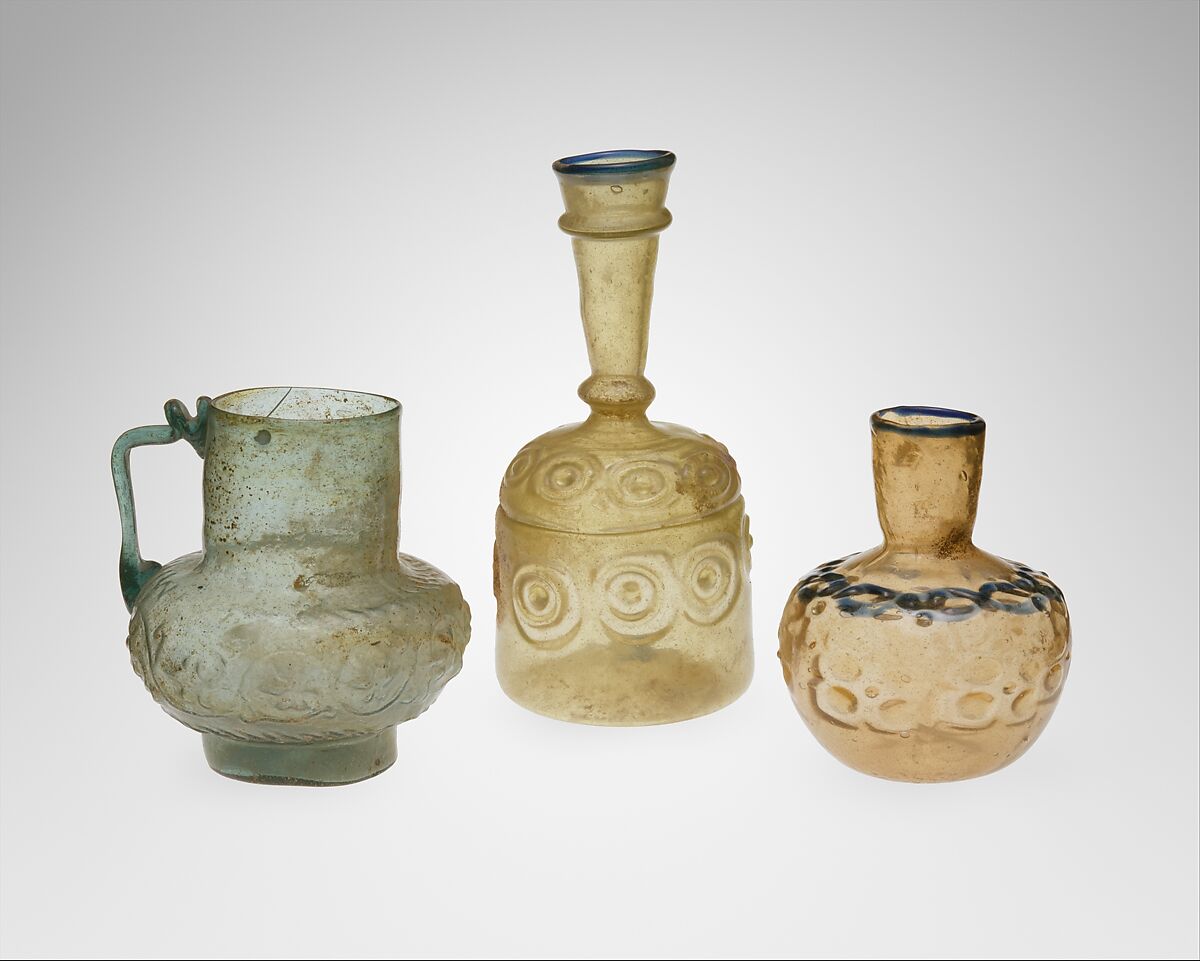 Short-Necked bottle, Glass, colorless with brown tinge; blown, impressed with tongs, applied blue rim and decoration