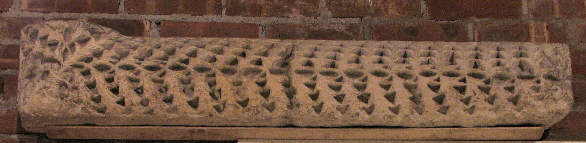 Fragment from a Molding with Vines and an Amphora (Vase), Limestone; carved in relief