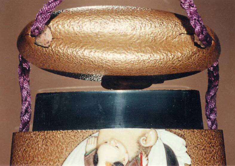 Case (Inrō) with Design of Hotei (Putai) Carrying a Small Boy (obverse); Boy Carrying Gourd-Flask (reverse), Tokoku Fuzui, Gold lacquer with ivory and wood inlay; Netsuke: ivory and lacquered wood figure, Ojime: gold bead with face of Daikoku, god of good fortune, Japan