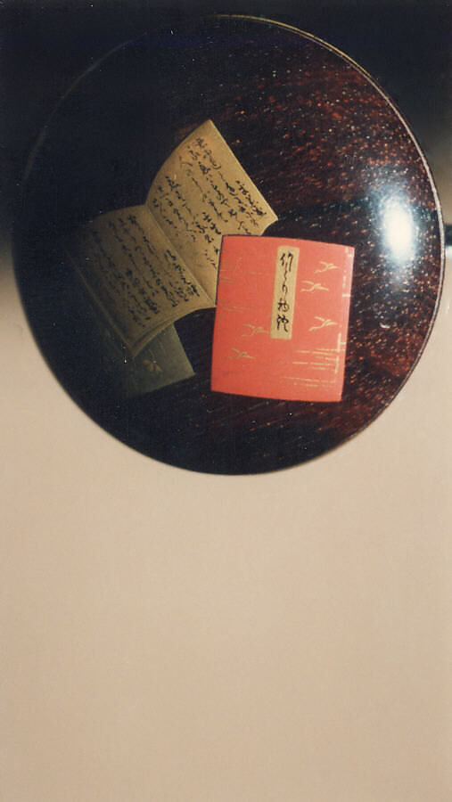 Case (Inrō) with Design of Bugaku Hat (obverseI; Shō Flute and Cymbals (reverse), Sprinkled gold lacquer with inlaid mother-of-pearl, pottery, and pewter; Interior: nashiji and fundame; Ojime: marble; Netsuke: wood with lacquer decoration of books, Japan