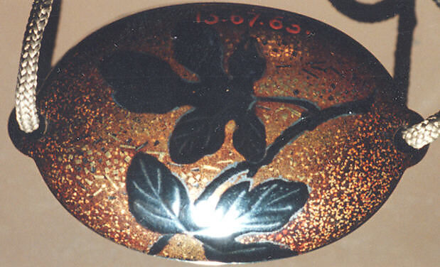 Case (Inrō) with Design of Chrysanthemums, Black and sprinkled gold lacquer; Ojime: tiger-eye bead; Netsuke: cluster of masks carved in ivory, Japan