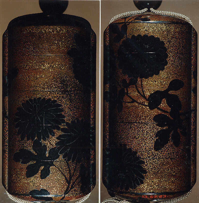 Case (Inrō) with Design of Chrysanthemums, Black and sprinkled gold lacquer; Ojime: tiger-eye bead; Netsuke: cluster of masks carved in ivory, Japan 