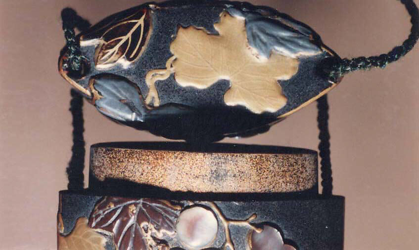 Case (Inrō) with Design of Grapevine, Case: gold and colored lacquer on black lacquer with mother-of-pearl and pewter inlays; Fastener (ojime): silver vase (signed: Tenni); Toggle: (netsuke): gold with design of cricket and dragonfly with autumn grasses, Japan