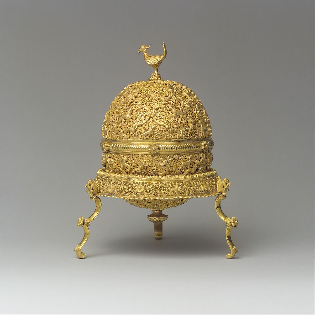 Goa Stone and Gold Case, Container: gold; pierced, repoussé, with cast legs and finials
Goa stone: compound of organic and inorganic materials 