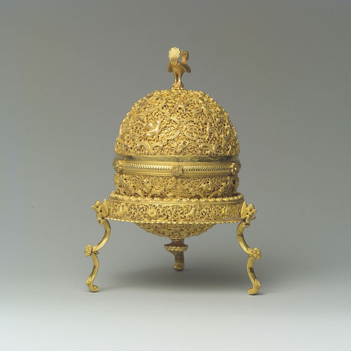 Goa Stone and Gold Case, Container: gold; pierced, repoussé, with cast legs and finials
Goa stone: compound of organic and inorganic materials