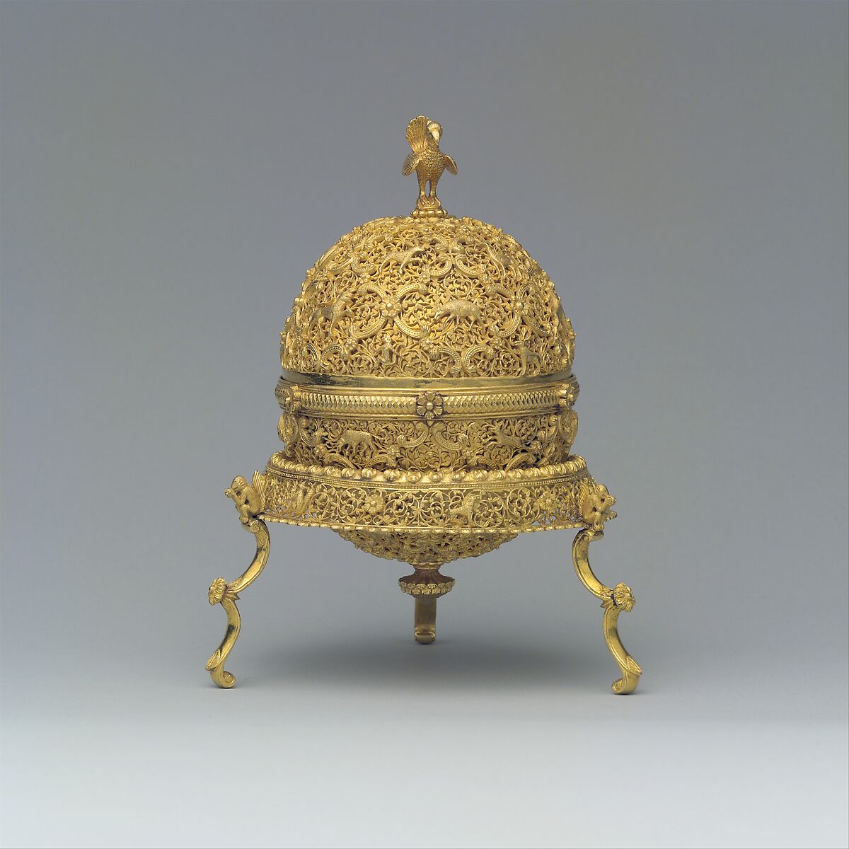 Goa Stone and Gold Case, Container: gold; pierced, repoussé, with cast legs and finials
Goa stone: compound of organic and inorganic materials