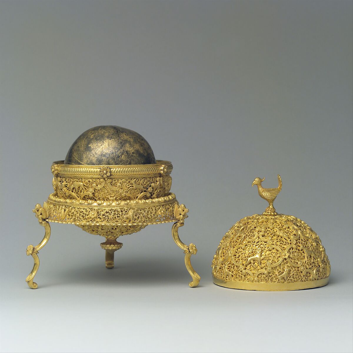 Goa Stone and Gold Case, Container: gold; pierced, repoussé, with cast legs and finials
Goa stone: compound of organic and inorganic materials