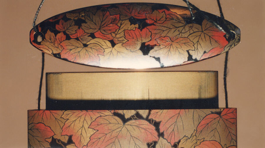 Inrō with Autumn Ivy, Attributed to Koma Kyūhaku VI (Japanese, died 1816), Four cases; lacquered wood with gold, silver, and color (iroko) togidashimaki-e on black lacquer ground
Netsuke: ivory; folded letter decorated with paulownia and Genji incense symbols 
Ojime: oblong bead; gilt bronze with openwork design of autumn flowers, Japan