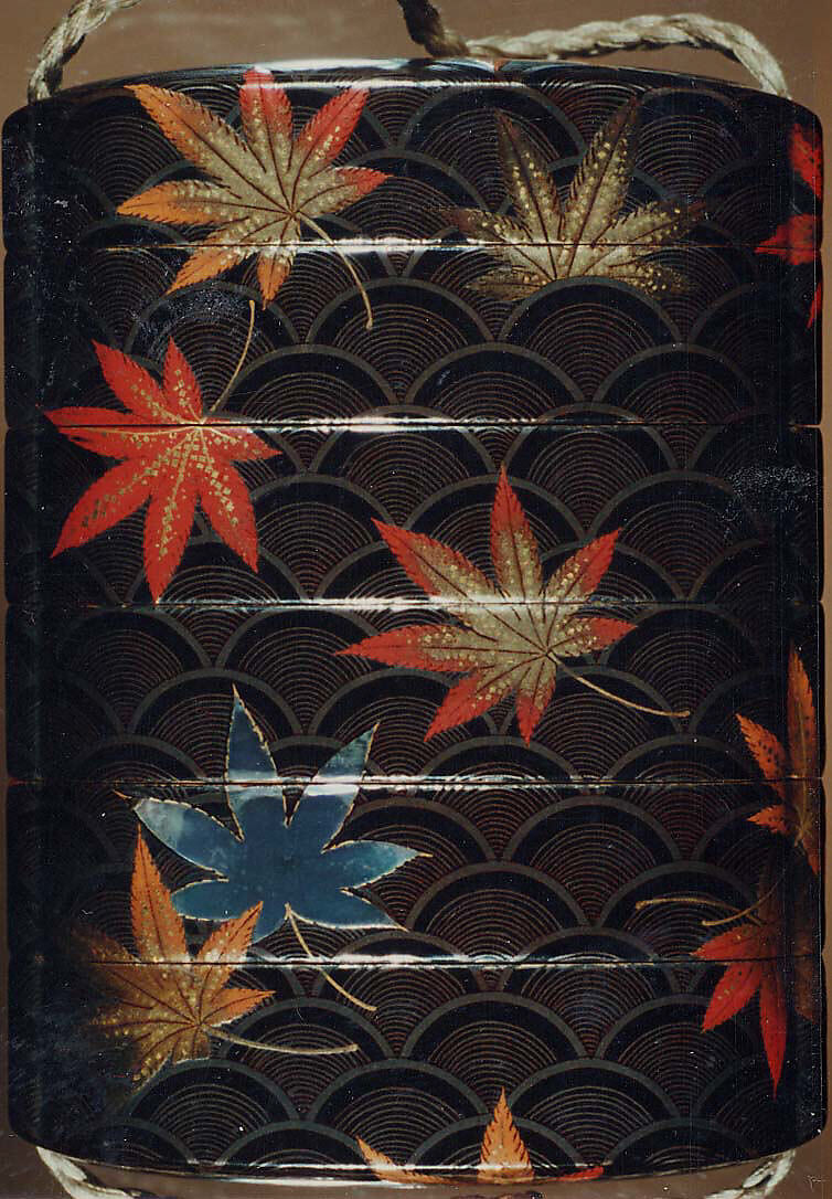 Case (Inrō) with Design of Maple Leaves on Conventionalized Waves, Sprinkled gold and silver lacquer with inlaid mother-of-pearl; ojime is nut carved with dragon motifs; netsuke is dancer carved in wood with ivory bugaku mask; Interior: nashiji, fundame and roiro, Japan