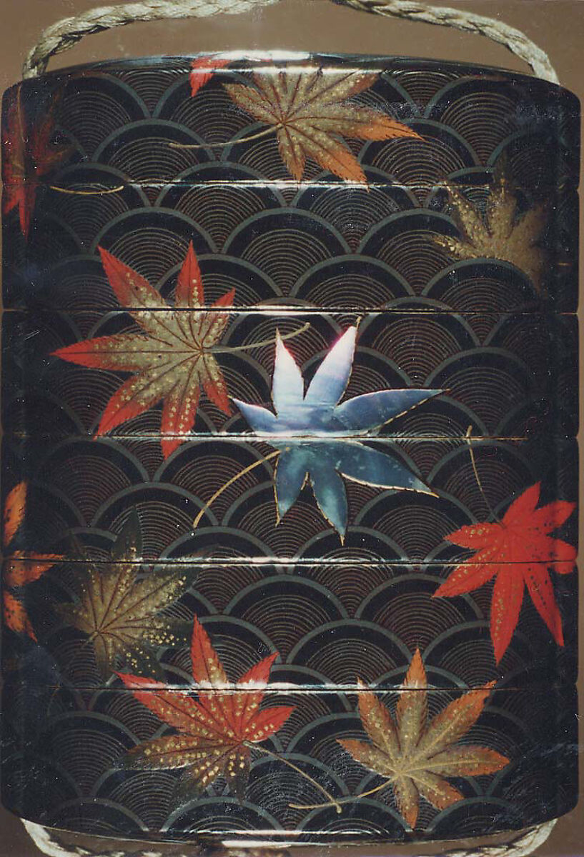 Case (Inrō) with Design of Maple Leaves on Conventionalized Waves, Sprinkled gold and silver lacquer with inlaid mother-of-pearl; ojime is nut carved with dragon motifs; netsuke is dancer carved in wood with ivory bugaku mask; Interior: nashiji, fundame and roiro, Japan