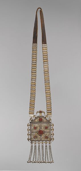 Amulet Holder, Silver and brass alloy; fire-gilded, with ram's-head terminals, loop-in-loop chains, bells, decorative wire, gilt-applied decoration, table-cut carnelians, and applique discs on leather 