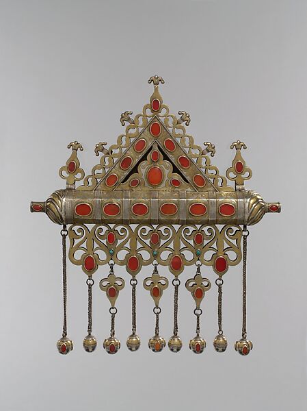 Amulet Holder, Silver; fire-gilded and chased, with decorative wire, ram’s-head terminals, openwork, slightly domed cabochon and table-cut carnelians, turquoise beads, wire chains, and spherical bells 