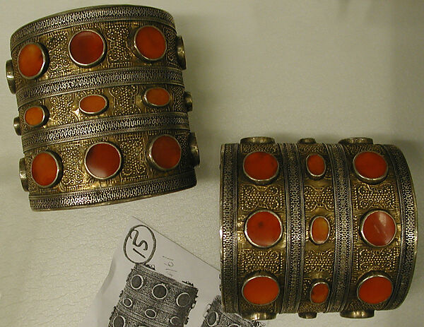 Armband, One of a Pair, Silver, chased, with gilt embossing, decorative wire, stamped beading, tablecut carnelians, and turquoise beads