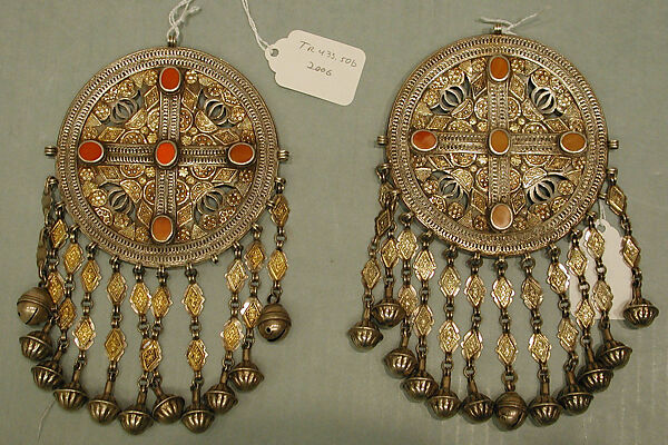 Pectoral Disc Ornament, One of a Pair, Silver with gilt applied decoration, openwork, decorative wire, connecting links with applied decoration, cone shaped and spherical bells, and table cut carnelians